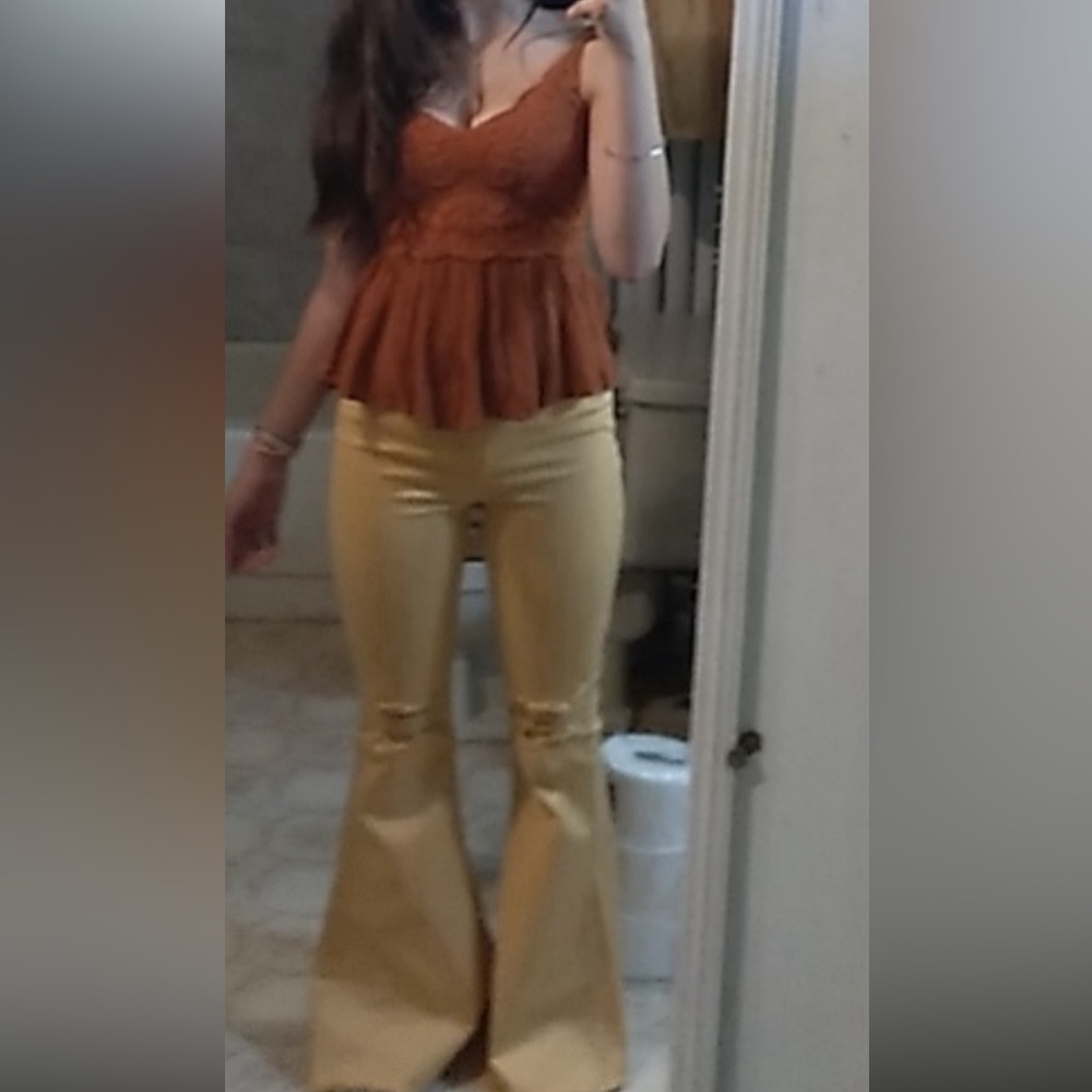 Yellow mid-rise flare jeans with ripped knees